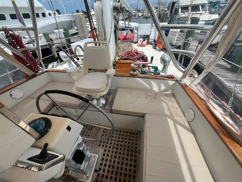 Slide: The Image of 1975 Cheoy Lee Offshore 53 MS sailboat cockpit with steering wheel and seating at marina. - 9