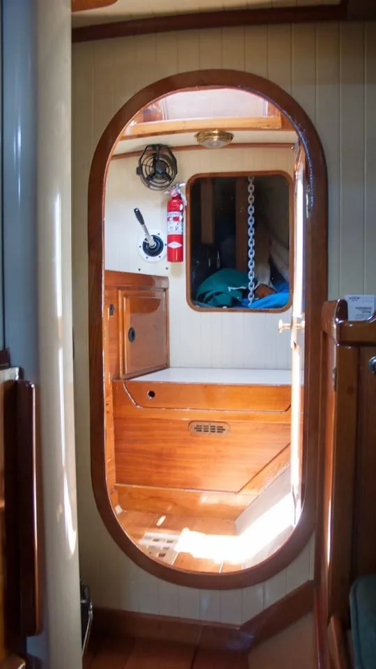 Slide: The Image of Interior of 2003 Bristol Channel Cutter Samuel Morse, featuring wooden cabinetry and nautical decor. - 13