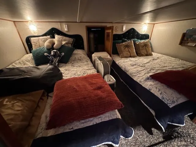 Slide: The Image of Cozy bedroom with twin beds in a 1994 Gibson 44 Standard boat. - 22
