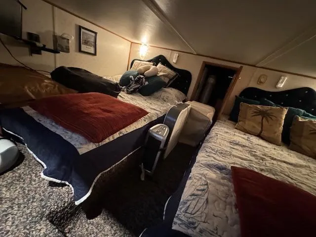Slide: The Image of Cozy bedroom with twin beds, warm lighting, and decorative pillows in a Gibson 44 Standard, 1994. - 24