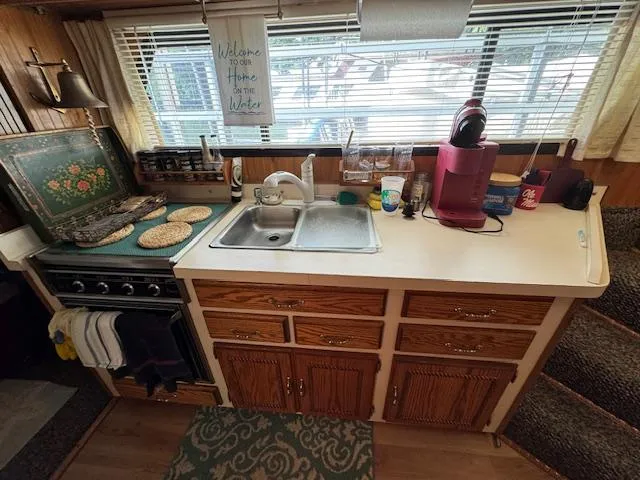 Slide: The Image of Cozy kitchen in a 1994 Gibson 44 Standard houseboat with wooden cabinets and appliances. - 32
