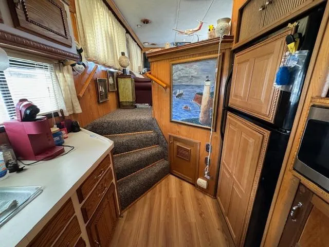 Slide: The Image of Interior of a 1994 Gibson 44 Standard houseboat with kitchen and stairs. - 33
