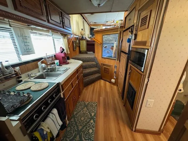 Slide: The Image of Interior of a 1994 Gibson 44 Standard houseboat with kitchen and wooden cabinetry. - 34