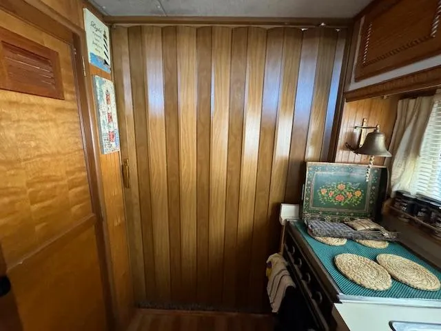 Slide: The Image of Cozy wooden interior of a 1994 Gibson 44 Standard with decorative elements and a small dining area. - 40