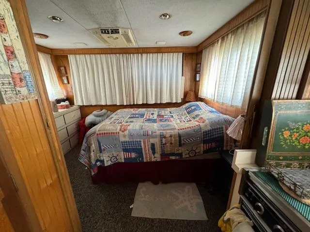 Slide: The Image of Cozy bedroom in a 1994 Gibson 44 Standard houseboat with nautical-themed quilt. - 41
