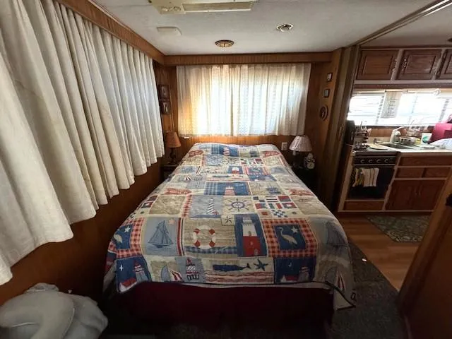 Slide: The Image of Cozy bedroom in 1994 Gibson 44 Standard houseboat with nautical-themed quilt. - 44