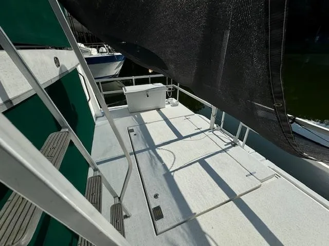 Slide: The Image of 1994 Gibson 44 Standard boat deck with ladder and shaded area. - 47