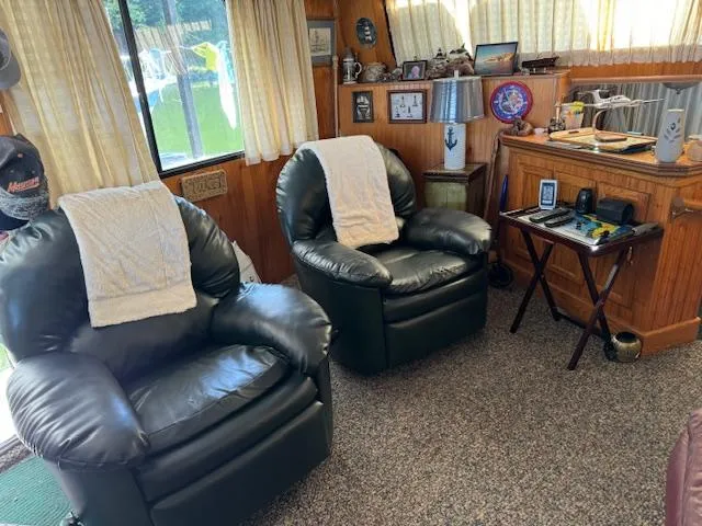 Slide: The Image of Cozy living room with leather chairs, nautical decor, and a Gibson 44 Standard model from 1994. - 7