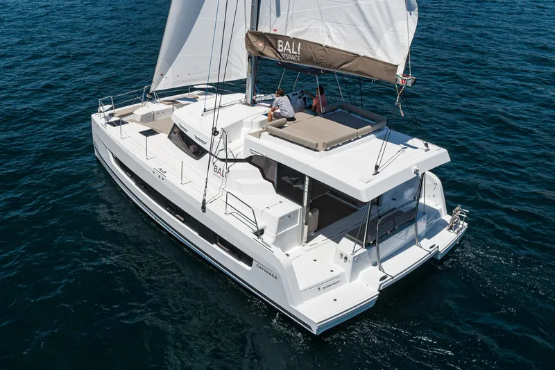 Slide: The Image of 2025 Bali CATSPACE catamaran sailing on open water, featuring spacious deck and modern design. - 13