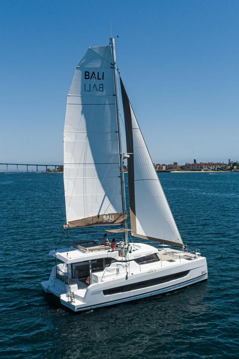Slide: The Image of 2025 Bali CATSPACE catamaran sailing on open water under clear blue skies. - 15