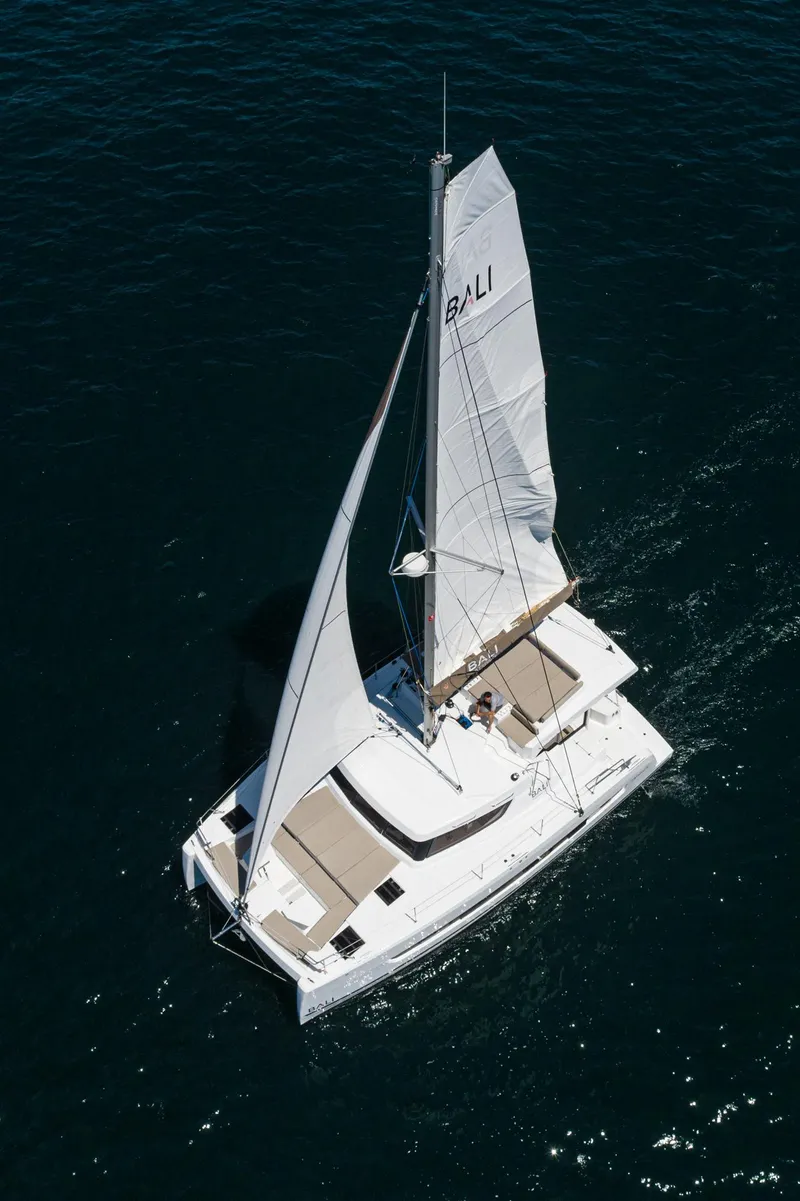 Slide: The Image of Aerial view of 2025 Bali CATSPACE catamaran sailing on open water. - 16