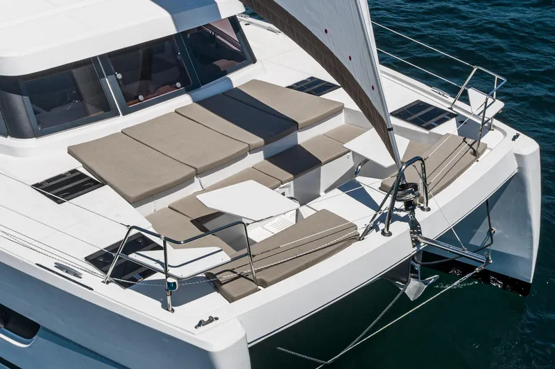 Slide: The Image of 2025 Bali CATSPACE catamaran with spacious deck and seating, sailing on clear blue water. - 20