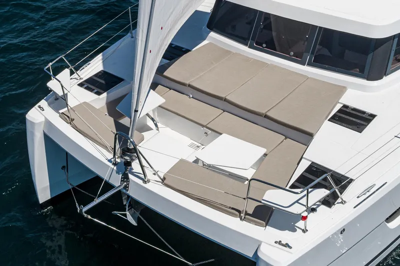Slide: The Image of 2025 Bali CATSPACE catamaran with spacious deck and seating, sailing on open water. - 21