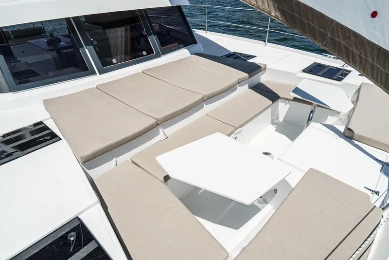 Slide: The Image of Luxurious 2025 Bali CATSPACE yacht deck with beige seating and white table. - 25
