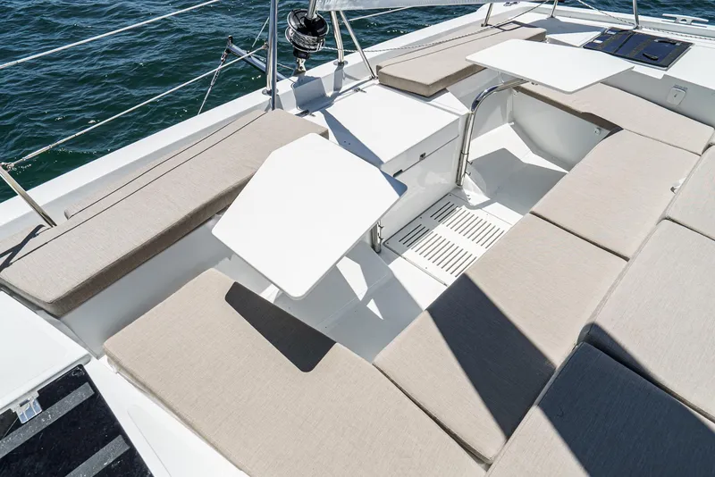 Slide: The Image of Spacious seating area on 2025 Bali CATSPACE catamaran with beige cushions and white tables. - 26