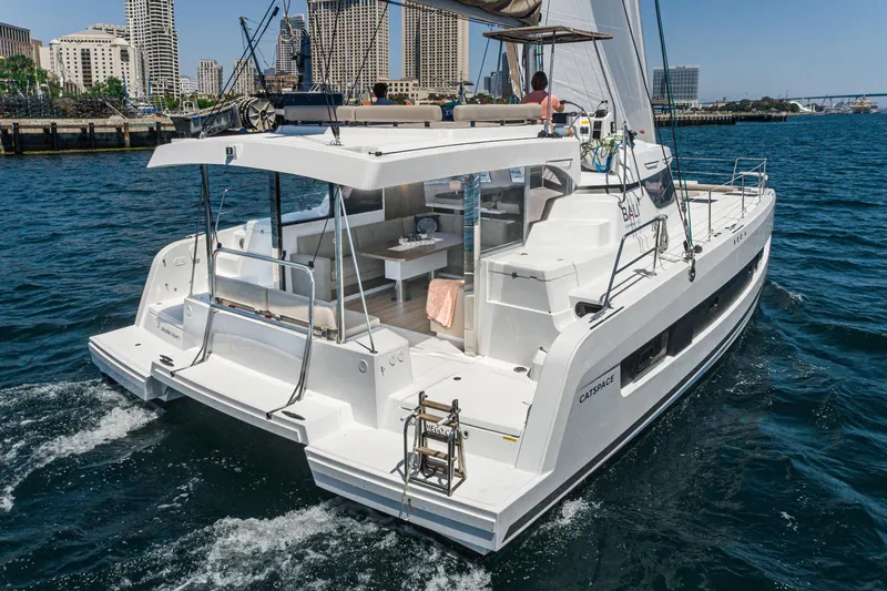 Slide: The Image of 2025 Bali CATSPACE catamaran sailing near city skyline. - 28