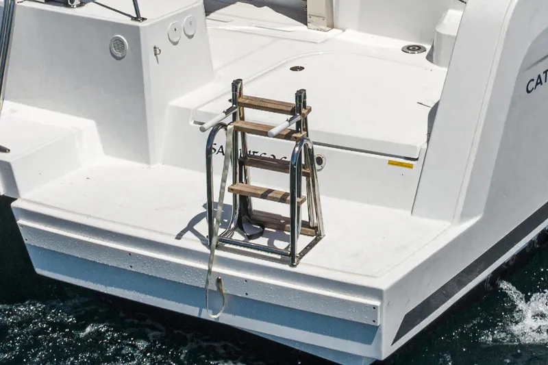 Slide: The Image of Bali CATSPACE 2025 yacht stern with ladder, floating on water. - 29