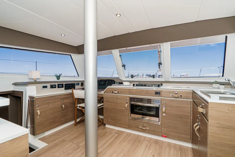 Slide: The Image of Modern kitchen interior of 2025 Bali CATSPACE yacht with wood cabinetry and large windows. - 42