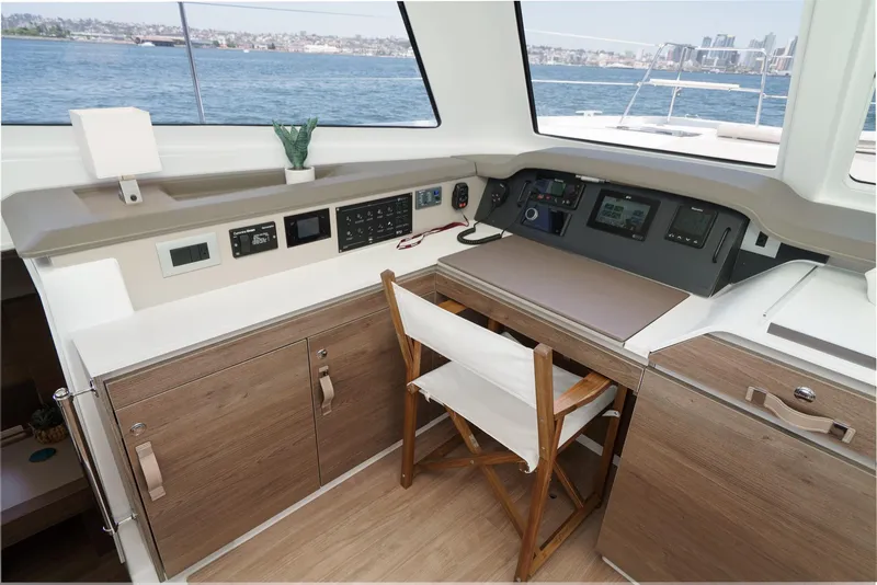 Slide: The Image of Interior of 2025 Bali CATSPACE yacht with navigation controls and wooden cabinetry. - 43