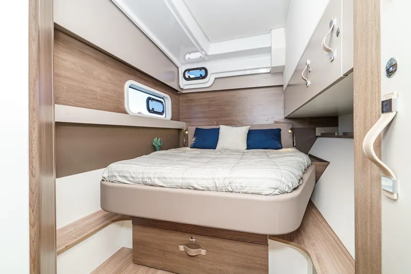 Slide: The Image of Modern cabin interior of 2025 Bali CATSPACE yacht with cozy bed and wooden accents. - 48