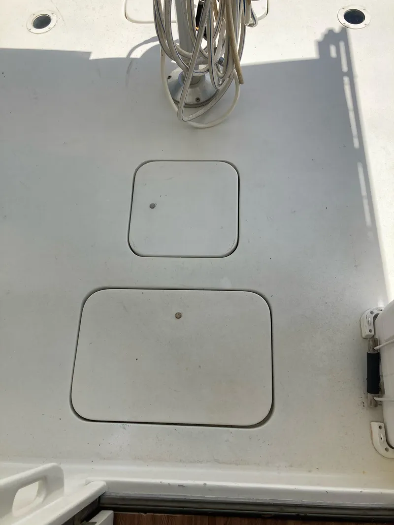 Slide: The Image of 1976 Hatteras 46 boat deck with storage hatches and coiled rope. - 13