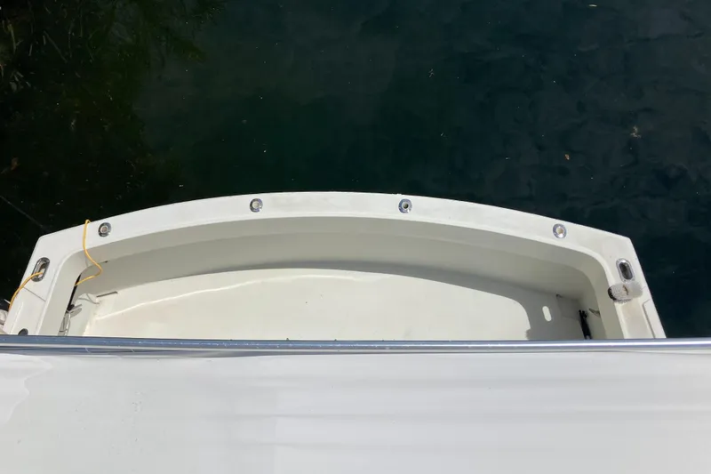 Slide: The Image of 1976 Hatteras 46 boat stern view on calm water. - 16