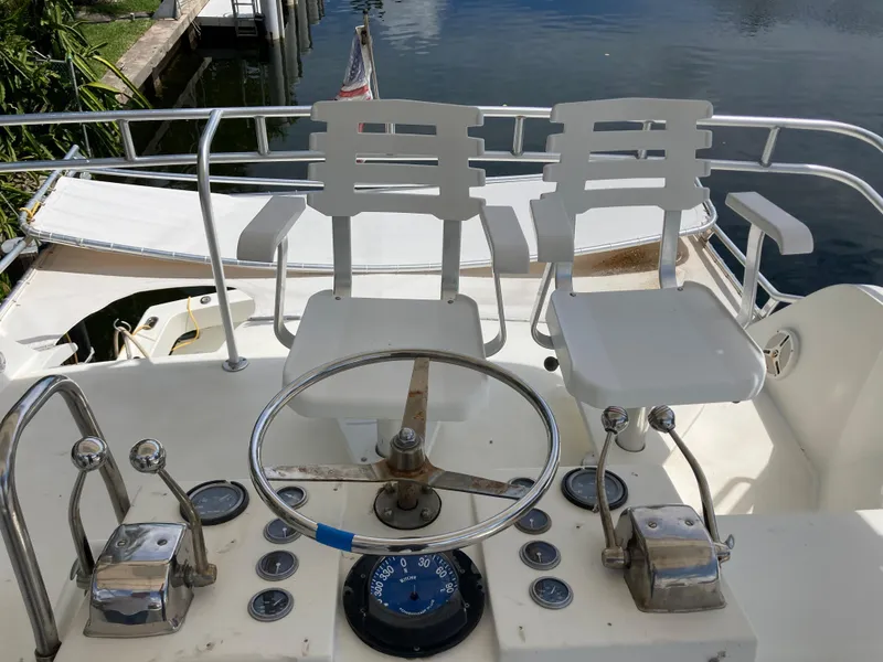 Slide: The Image of Helm of 1976 Hatteras 46 yacht with dual captain chairs and navigational controls. - 18