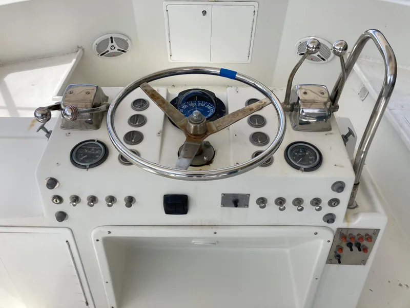 Slide: The Image of 1976 Hatteras 46 boat helm with steering wheel and control panel. - 20