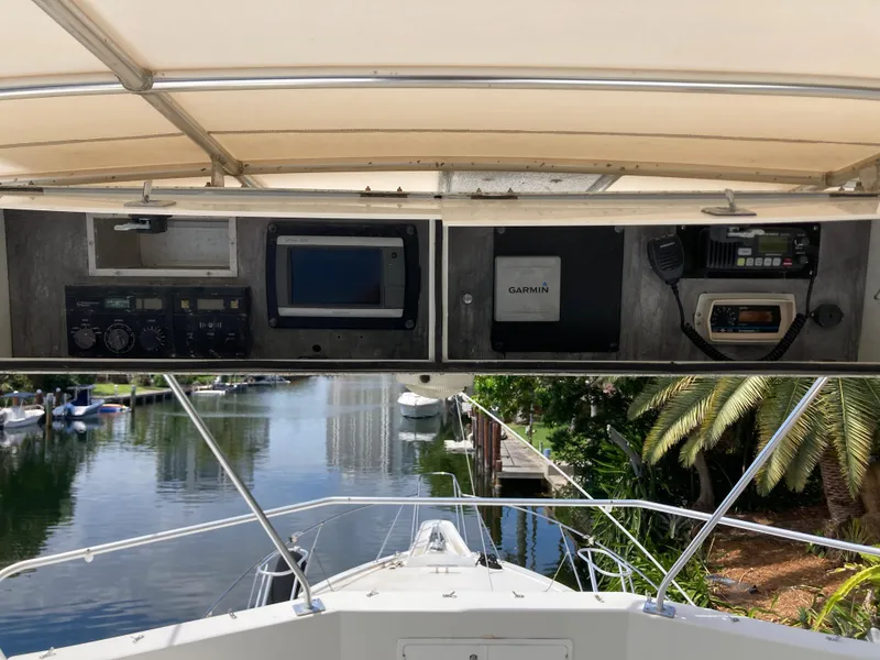Slide: The Image of 1976 Hatteras 46 yacht helm with navigation equipment and scenic waterway view. - 21
