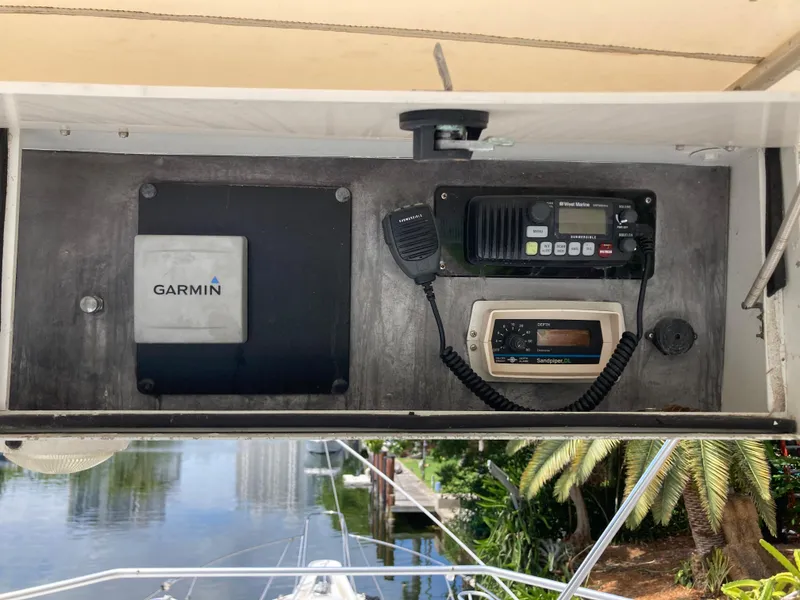 Slide: The Image of 1976 Hatteras 46 boat dashboard with Garmin navigation and communication equipment. - 22