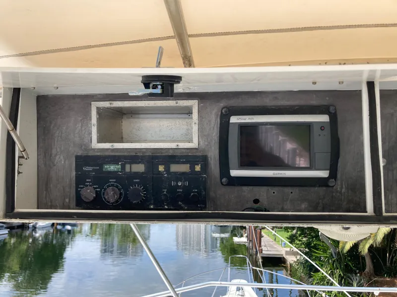 Slide: The Image of 1976 Hatteras 46 boat dashboard with navigation equipment and controls. - 23