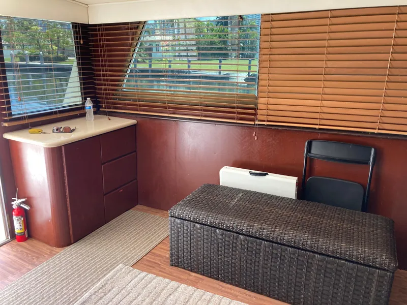Slide: The Image of Interior of 1976 Hatteras 46 yacht with wooden blinds and wicker storage bench. - 24
