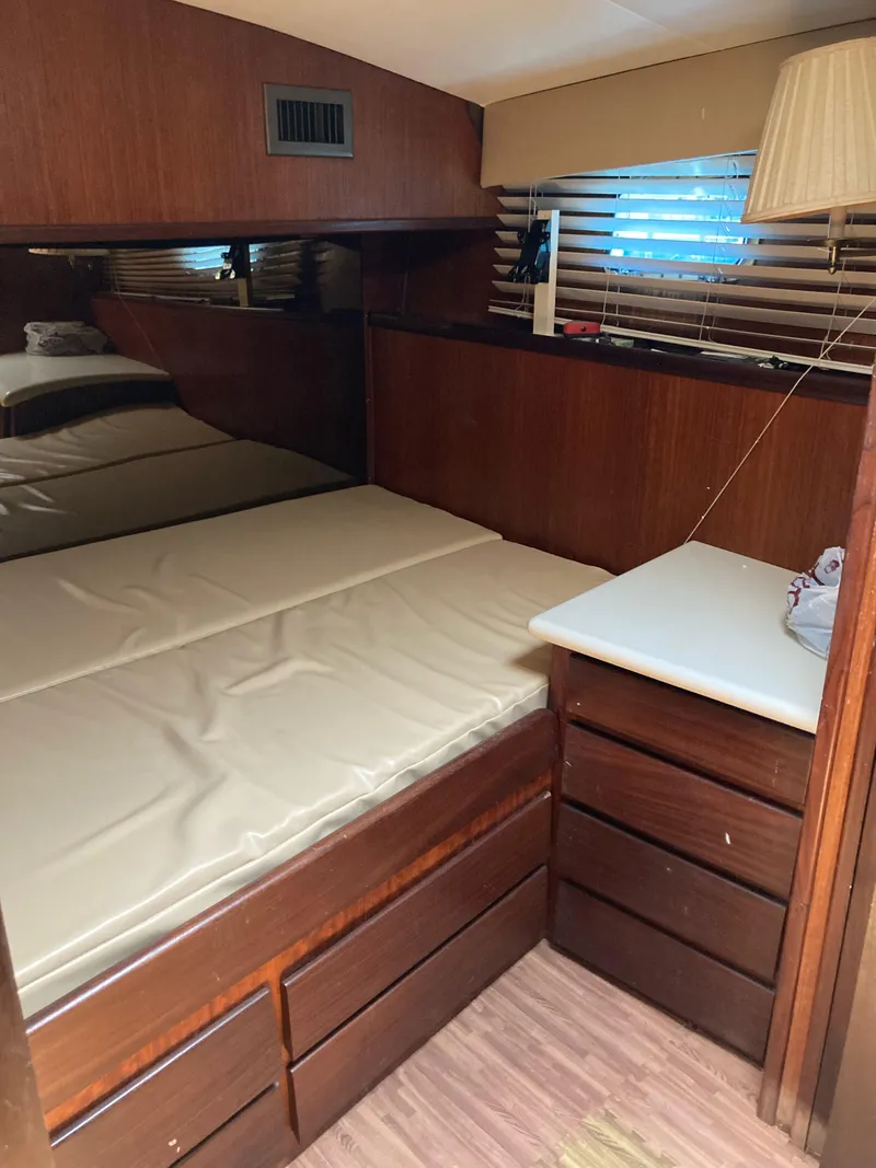 Slide: The Image of Cozy cabin interior of 1976 Hatteras 46 yacht with wooden furnishings. - 26