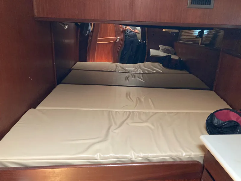 Slide: The Image of Interior cabin of 1976 Hatteras 46 yacht with twin beds and wood paneling. - 27