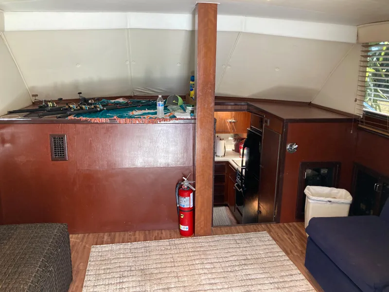 Slide: The Image of Interior of 1976 Hatteras 46 yacht with wood paneling and kitchenette. - 31