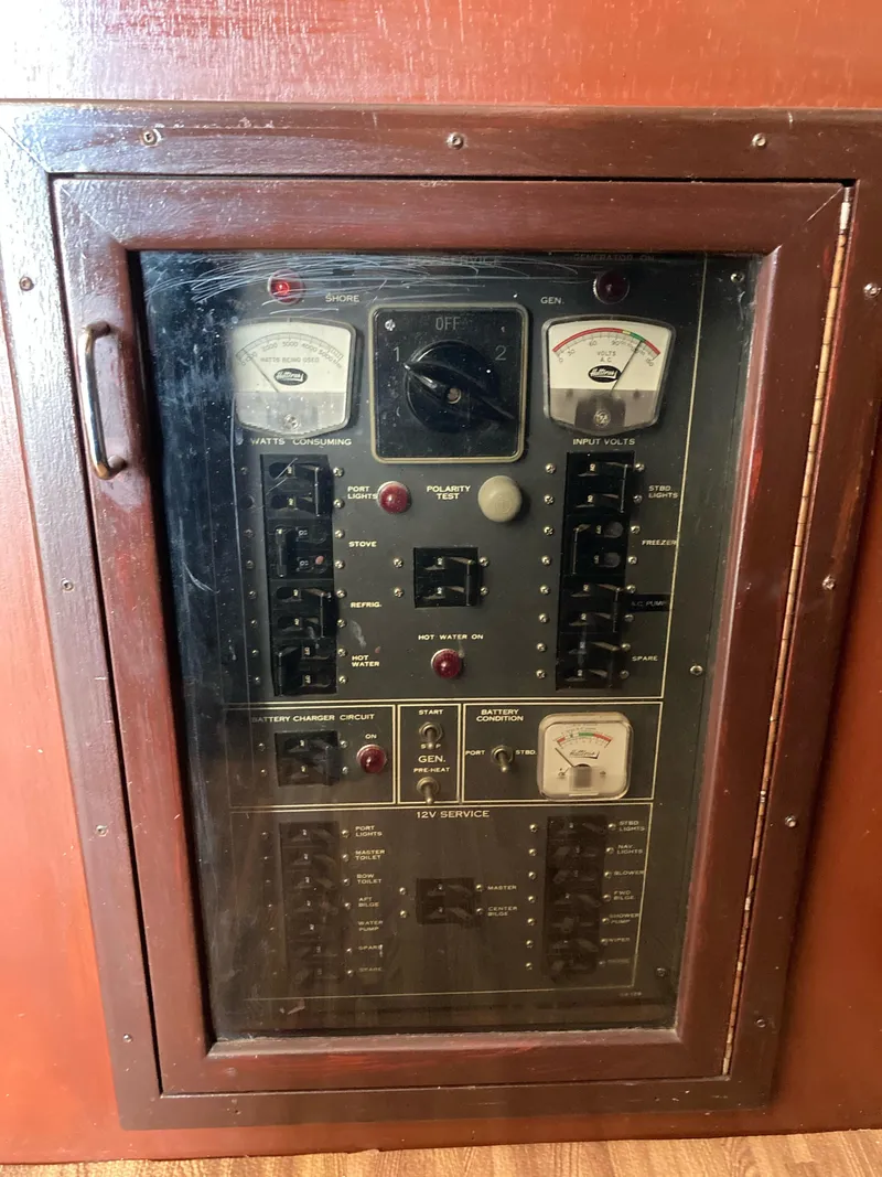 Slide: The Image of Electrical panel of a 1976 Hatteras 46 boat with gauges and switches. - 32
