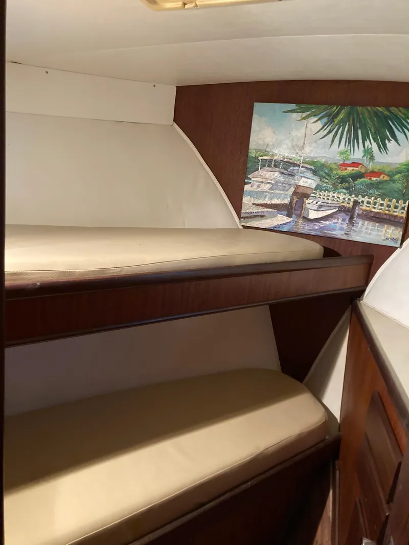 Slide: The Image of 1976 Hatteras 46 interior with bunk beds and nautical artwork. - 34