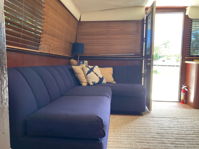 Slide: The Image of Interior of 1976 Hatteras 46 yacht with blue sofa and wooden blinds. - 40