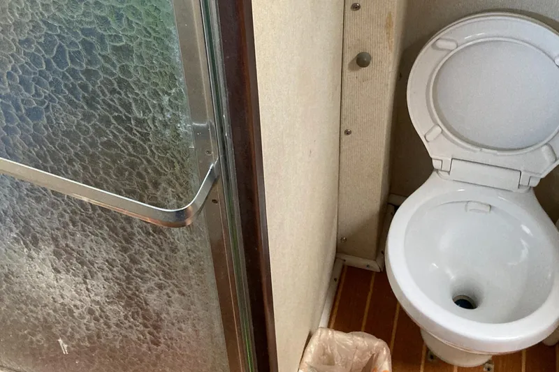 Slide: The Image of 1976 Hatteras 46 yacht bathroom with shower and toilet. - 44