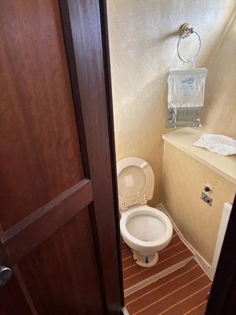 Slide: The Image of 1976 Hatteras 46 yacht bathroom with wooden flooring and compact design. - 45