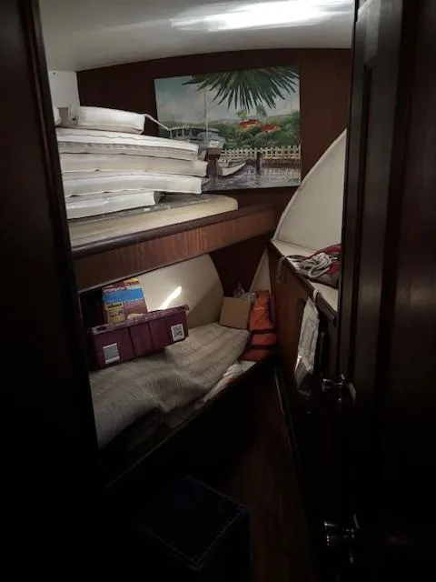 Slide: The Image of Interior cabin of a 1976 Hatteras 46 yacht with cozy sleeping area. - 48