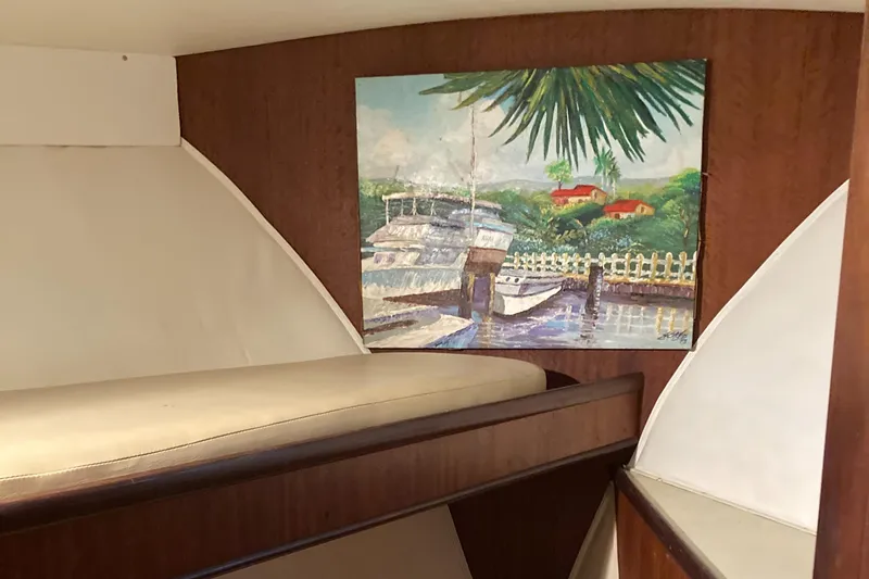 Slide: The Image of Interior of 1976 Hatteras 46 yacht with wall art and wooden accents. - 50
