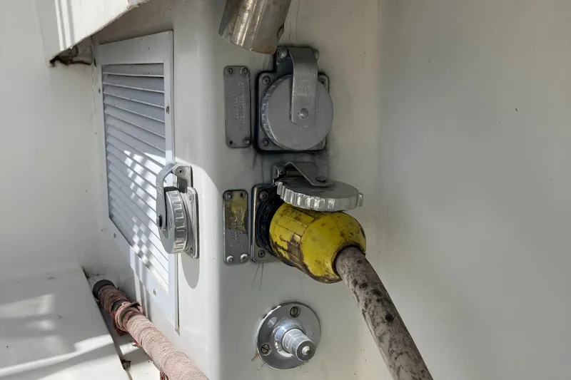 Slide: The Image of Electrical connections on a 1976 Hatteras 46 boat, featuring power and ventilation components. - 51