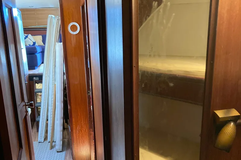 Slide: The Image of 1976 Hatteras 46 interior with wooden doors and bunk beds. - 53
