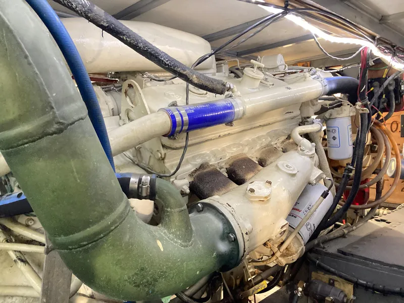 Slide: The Image of Engine of a 1976 Hatteras 46 yacht, showcasing intricate mechanical components. - 56