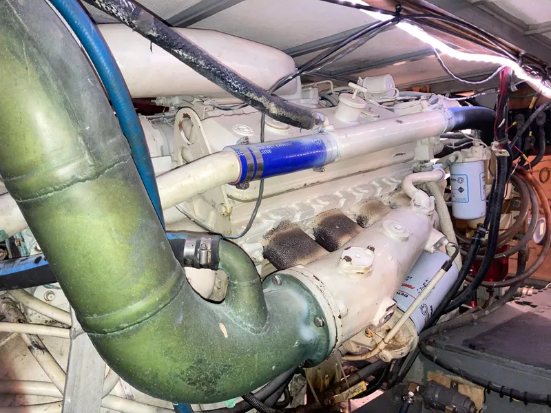 Slide: The Image of Engine room of a 1976 Hatteras 46 yacht, showcasing detailed mechanical components. - 59