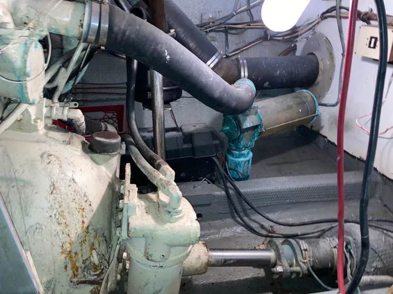 Slide: The Image of Engine room of a 1976 Hatteras 46 yacht, showing mechanical components and wiring. - 60