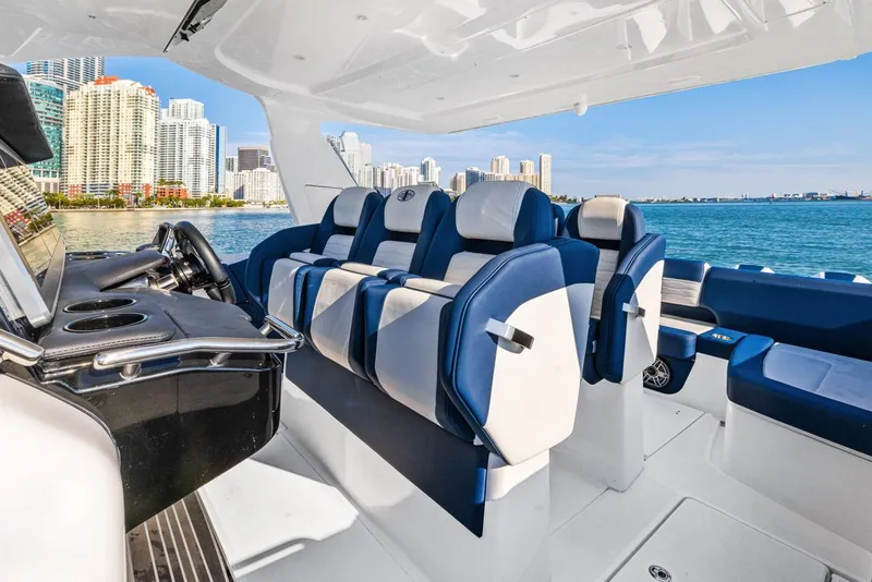 Slide: The Image of Luxurious 2023 Cigarette 42 Auroris boat interior with blue and white seating, city skyline view. - 15