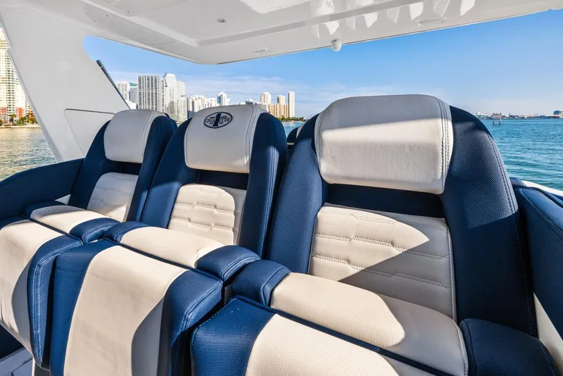 Slide: The Image of Luxurious seating on 2023 Cigarette 42 Auroris boat, with city skyline in background. - 16