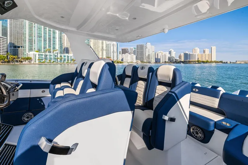 Slide: The Image of 2023 Cigarette 42 Auroris luxury boat interior with blue and white seating, city skyline view. - 17